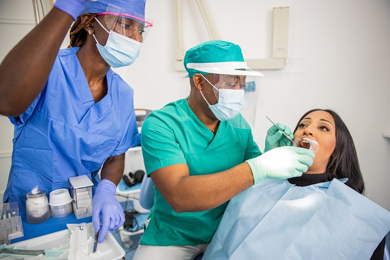 A dentist checks a patient's teeth in an African dental clinic emergency