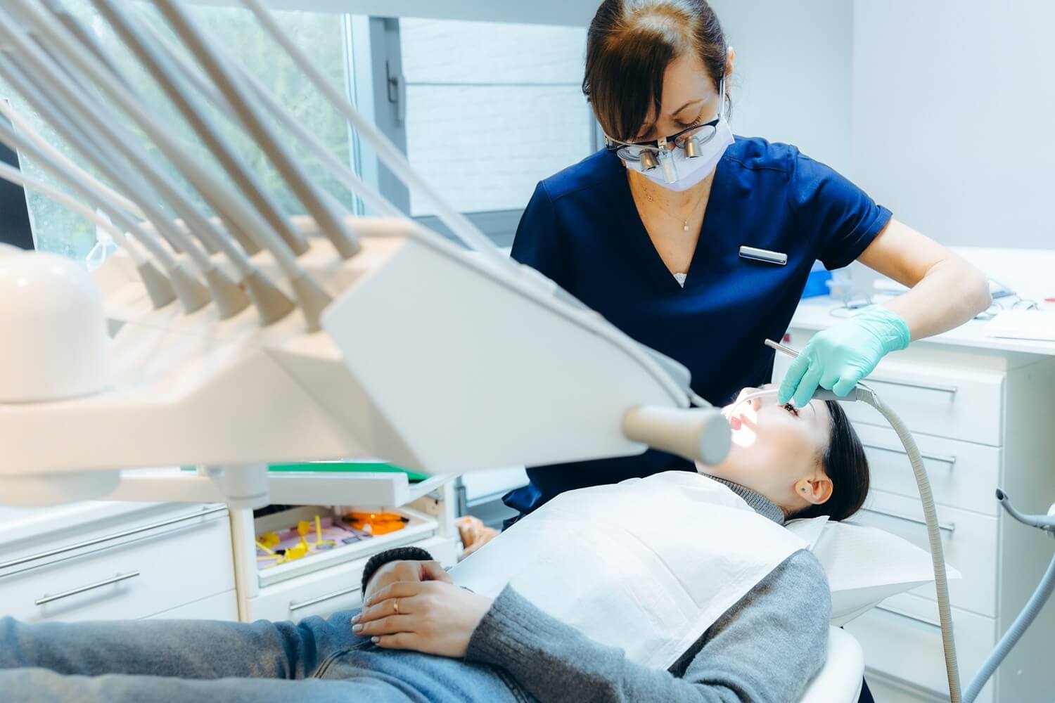 patient receives dental exam in modern clinic