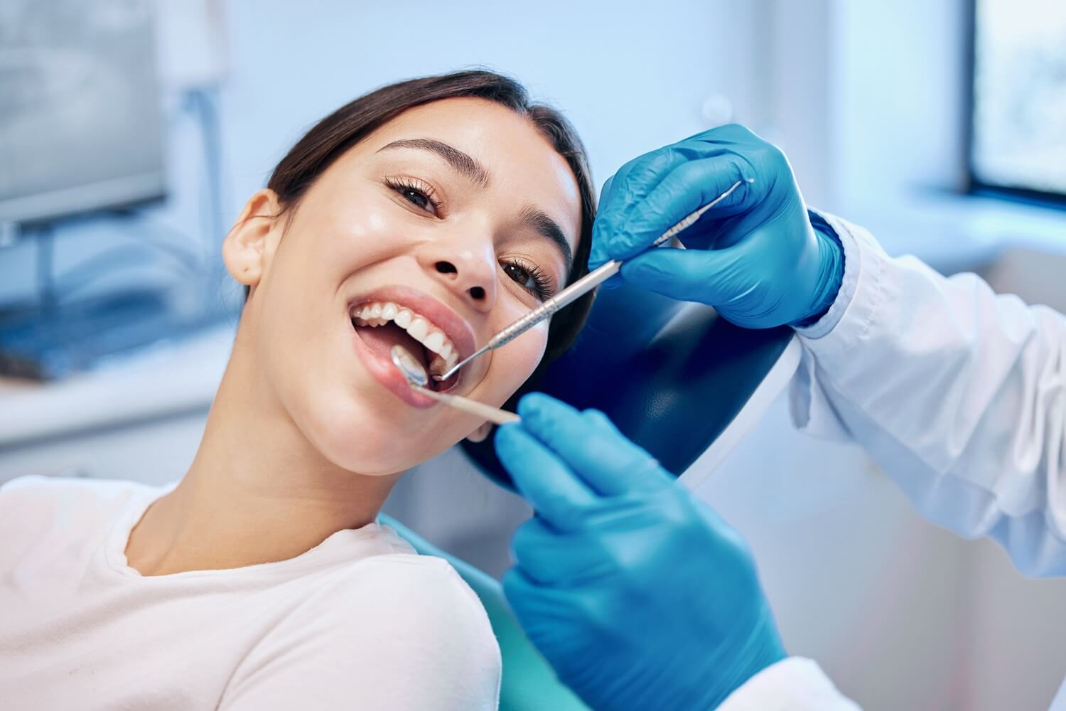 woman smiling during dental examination at clinic